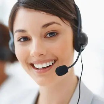 A woman wearing headphones and smiling for the camera.