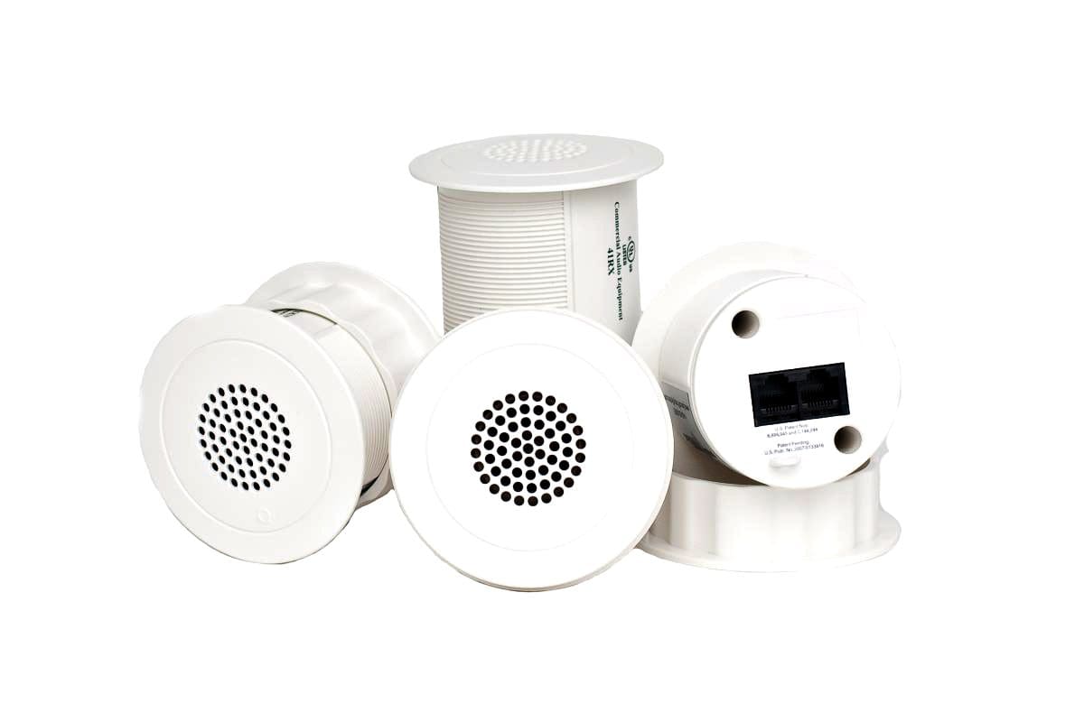 A group of white speakers sitting next to each other.