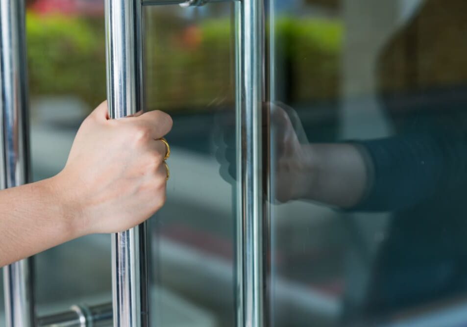 Woman's,Hand,Open,The,Door,With,Glass,Reflection,Background