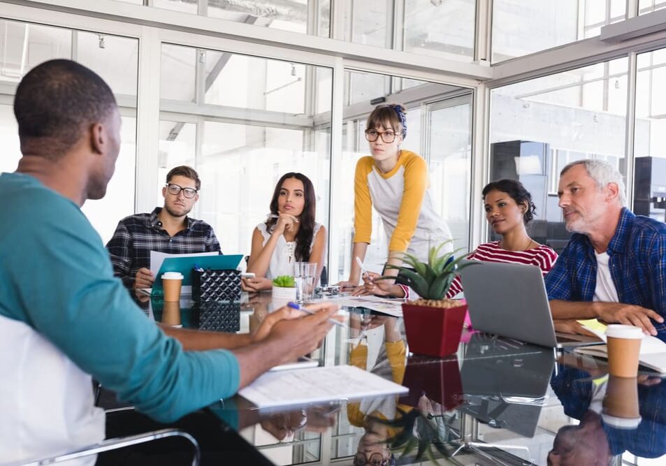 Business,People,Discussing,At,Desk,During,Meeting,In,Office Business,People,Discussing,At,Desk,During,Meeting,In,Office